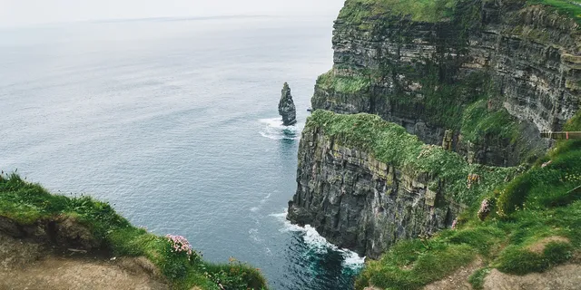 view to a cliff surrounded by the sea