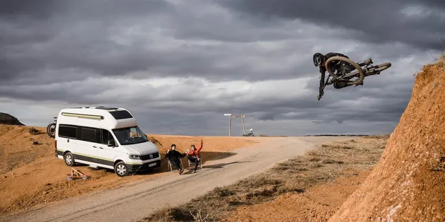 Mountain biking in front of Grand California Campervan