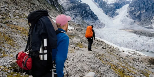 Two friends in hiking equipment while hiking in a Norwegian glacier. Norway Secret tips and alternatives to the most popular spots we will tell you here.