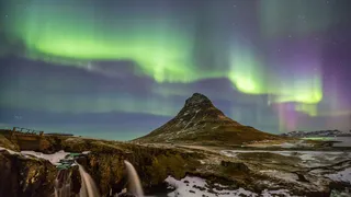 Northern lights over mountainous landscape