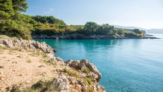 Stone bay on the island of Krk in Croatia with views of the turquoise blue sea