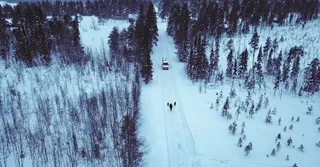 A camper on a snowy street in Norway.