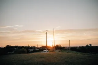 Camper rides through the sunset