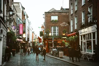 small street with houses on the side and cafés