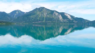 View from the water on the turquoise blue Walchensee in Upper Bavaria and the mountains
