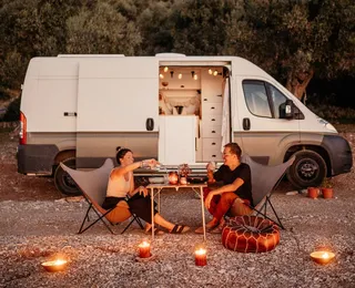 Jessi and Markus at dinner in front of their camper.