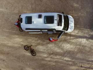 VW Grand California from above with mountain bikers.