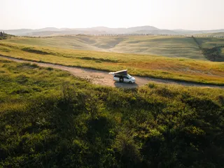 Camper on a way between fields
