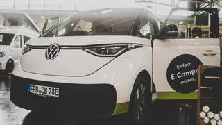 The electric camper VW ID.Buzz with open driver door.