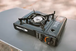 Camping stove stands on camping table